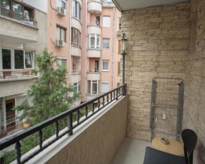 a balcony with a view of a building at Aleks Holiday-center,sea,parking in Burgas City