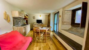 eine Küche und ein Esszimmer mit einem Tisch und Stühlen in der Unterkunft La casa di Tommy in Savoulx