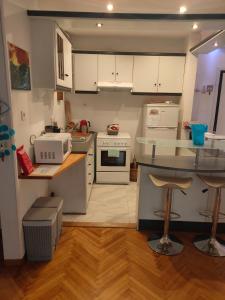 a kitchen with white appliances and a counter top at Athens Riviera apt with seaview, 15' to Acropolis in Athens