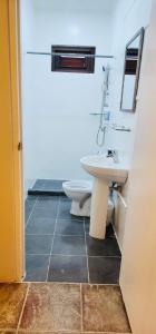 a bathroom with a toilet and a sink at One Bedroom Apartment Near the Beach in Jan Thiel