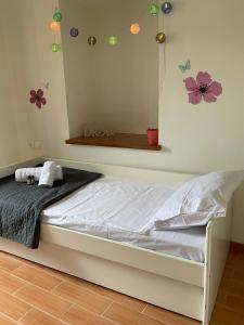 a bedroom with a bed with flowers on the wall at Camellia Guesthouse in Anilio Pelion