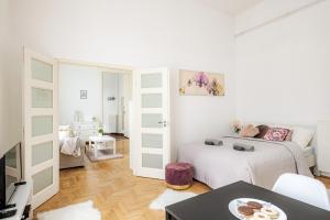 a white room with a bed and a table at Vintage Home next to Central Market Hall in Budapest