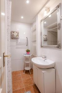 a white bathroom with a sink and a mirror at Vintage Home next to Central Market Hall in Budapest +12 photos