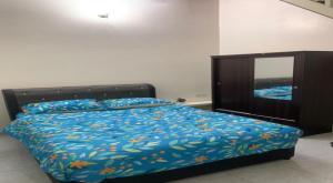 a bedroom with a bed with a dresser and a mirror at Hostel KLIA in Sepang