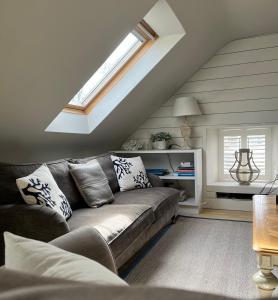 a living room with a couch and a window at The Dreel Loft in Anstruther