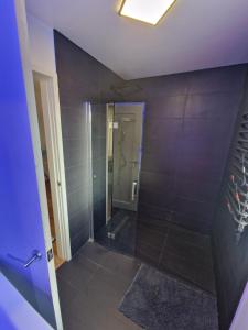 a bathroom with a shower with a glass door at Stunning 3 bed house sleeps6 in Nottingham