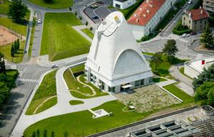 an image of a large white building with a satellite at Le Corbusier - Cosy & SPA - Appartement in Firminy