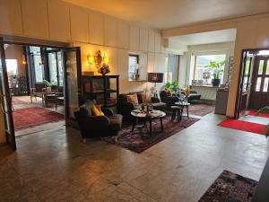 a living room with couches and chairs and tables at Hotel Lysekil in Lysekil