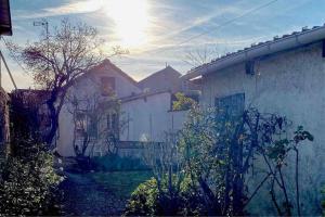 Ein weißes Haus mit der Sonne am Himmel in der Unterkunft Le Nî’ De Jess in Migennes