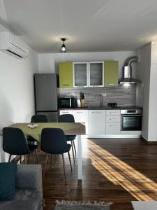 a kitchen with a table and chairs in a room at Apartman Mila in Biograd na Moru