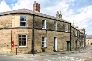 an old brick building on the corner of a street at Algernon House in Alnwick