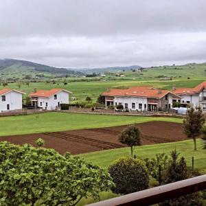 a group of houses in a field with a farm at Casa vacacional Ajo in Ajo