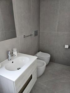 a bathroom with a white sink and a toilet at Hotel Admiral in Bellaria-Igea Marina