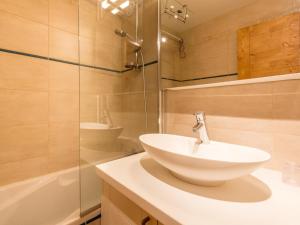 a bathroom with a sink and a glass shower at Appartement rénové avec wifi, garage et balcon sud à Val-d'Isère - FR-1-694-232 in Val dʼIsère +6 photos