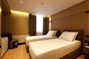 Postel nebo postele na pokoji v ubytování Caramel Boutique Hotel