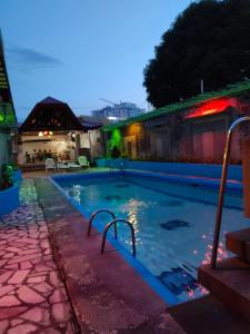 a swimming pool in a house at night at 2 Hotel Saleh in Angeles