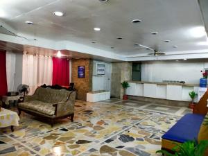 a living room with a couch and a red curtain at 2 Hotel Saleh in Angeles +172 photos
