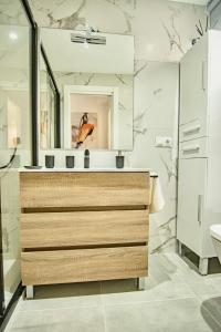 a bathroom with a sink and a mirror at Amazing Old Town Penthouse II - EaW Homes in Marbella