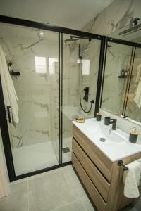 a bathroom with a shower and a sink and a glass shower stall at Amazing Old Town Penthouse II - EaW Homes in Marbella