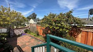 a green bench in front of a fence at 3 bedroom residential home in the lovely town near SFO San Francisco in Millbrae