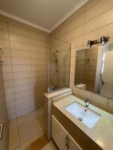 a bathroom with a sink and a mirror at Almaza Bay Beach Town Chalet in Marsa Matruh