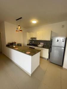 a kitchen with a refrigerator and a counter top at Almaza Bay Beach Town Chalet in Marsa Matruh +15 photos