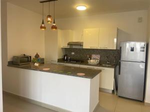 a kitchen with a refrigerator and a counter top at Almaza Bay Beach Town Chalet in Marsa Matruh