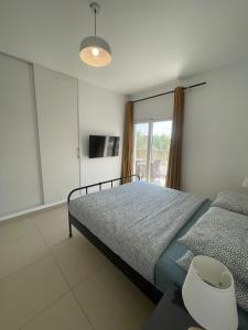 a bedroom with a bed and a window at Almaza Bay Beach Town Chalet in Marsa Matruh