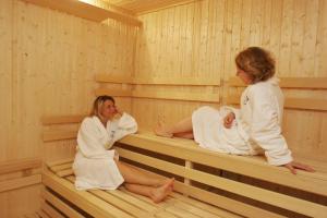 two women are sitting in a sauna at Pension Akropolis, eco breakfasts from farm in Mariánské Lázně