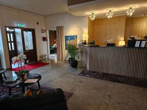 a lobby with a reception desk in a building at Hotel Lysekil in Lysekil