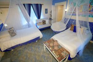 a bedroom with two beds with mosquito nets at The Legend Garden Condos in Saint Peter +21 photos