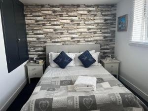 a bedroom with a bed with a stone wall at Beachfront retreat apartment with amazing terrace in Hastings