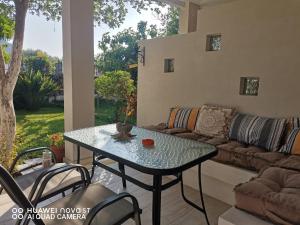 a table and chairs in a living room with a couch at Nely's Luxury Home in Nydri