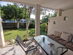 a patio with a glass table and a couch at Nely's Luxury Home in Nydri