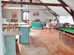 a large room with a pool table and tables at Gîte La Roche-Neuville, 6 pièces, 14 personnes - FR-1-600-148 in Loigné-sur-Mayenne