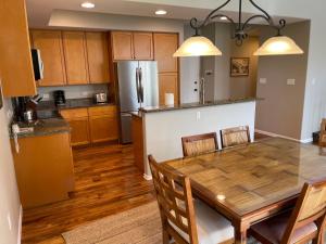 a kitchen and dining room with a wooden table at Summer Special! Hilton Pool Pass included! in Waikoloa