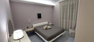 a bedroom with a bed with two pillows on it at La Villetta di Sabrina in Marsala