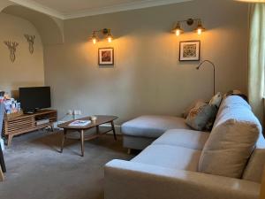 a living room with a couch and a table at Divine, detached countryside cottage near Ludlow. in Ludlow