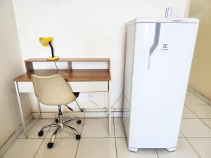 a desk and a refrigerator in a room with a chair at Apto com Vista total da Praia de Copacabana TC802 in Rio de Janeiro