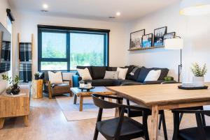 a living room with a couch and a table at Ghost Peak by Revelstoke Vacations in Revelstoke