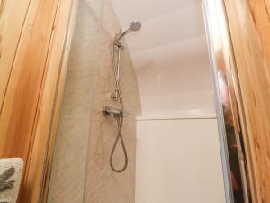 a shower with a shower head in a bathroom at Homewood Pod in Preston