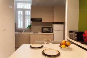 a kitchen with a table with a bowl of fruit on it at A Casa di Nonna in Bisceglie