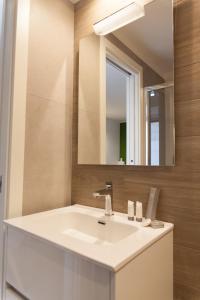 a bathroom with a white sink and a mirror at A Casa di Nonna in Bisceglie