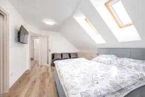 a bedroom with a bed and a skylight at Chalupa ODDECH in Lipno nad Vltavou
