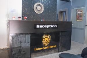 a reception desk with a lions surf hotel sign on it at Lions Suit Hotel in Istanbul