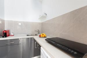 a kitchen with a sink and a stove top oven at Apartment Tanja Oldtown in Split
