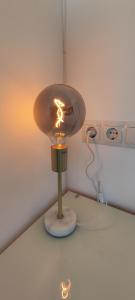 a light on a table in a room at Chill Out Studio Jacuzzi & Sea Views in Alicante