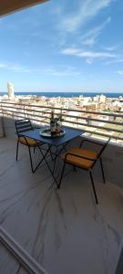 a table and chairs on a balcony with a view at Chill Out Studio Jacuzzi & Sea Views in Alicante