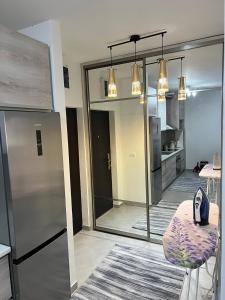 a room with a kitchen with a refrigerator and a stool at Apartman darko in Becici