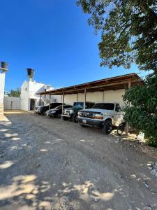 a group of cars parked in front of a garage at Hotel y Piscina Villa Maria Uribia in Uribia